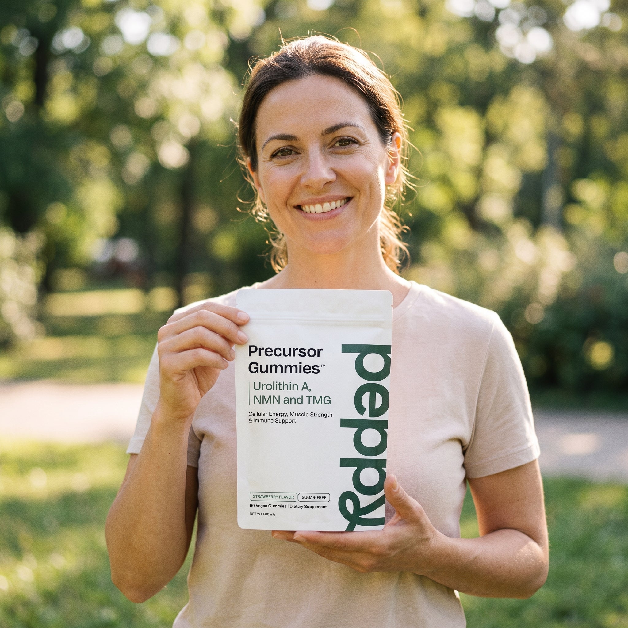 A woman holding Peppy Precursor Gummies outdoors